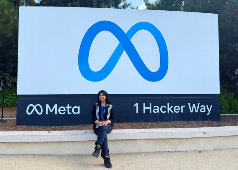 a person sitting in front of the Meta sign in Melo Park California